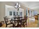 Elegant dining room featuring hardwood floors, a round table with chairs, and ample natural light from many windows at 2000 Taney Way, Indian Land, SC 29707