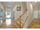 Inviting entryway with hardwood floors, staircase, and a glimpse of the front yard through an open door at 2000 Taney Way, Indian Land, SC 29707