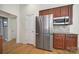 Kitchen area featuring stainless steel refrigerator, wood cabinets, and granite countertops at 2000 Taney Way, Indian Land, SC 29707