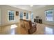 Bright living room featuring hardwood floors, neutral walls, and large windows providing natural light at 2000 Taney Way, Indian Land, SC 29707