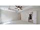 Bright bedroom with neutral carpet, tray ceiling, and doors leading to en-suite bathroom and walk-in closet at 2000 Taney Way, Indian Land, SC 29707