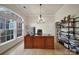 Elegant office featuring a large wooden desk, bright window, chandelier lighting, and hardwood floors at 2000 Taney Way, Indian Land, SC 29707