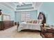 Cozy bedroom with a coffered ceiling, classic furnishings, neutral carpet and a bright window at 2369 Stardust Ct, Denver, NC 28037