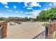 Community pool with lounge chairs, tables, and a pergola surrounded by lush landscaping, providing a serene oasis at 2369 Stardust Ct, Denver, NC 28037