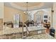 Dining area with chandelier, hardwood floors, and seamless flow to the living room and kitchen at 2369 Stardust Ct, Denver, NC 28037
