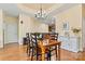 Dining room featuring hardwood floors, modern chandelier, and access to kitchen at 2369 Stardust Ct, Denver, NC 28037