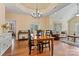 Dining room with hardwood floors and chandelier, connecting living and dining areas at 2369 Stardust Ct, Denver, NC 28037