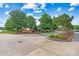 Welcoming community entrance with brick signage, colorful flowers, manicured landscaping, and mature shade trees at 2369 Stardust Ct, Denver, NC 28037