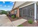 Brick home featuring a welcoming screened porch, dark shutters, and lush landscaping at 2369 Stardust Ct, Denver, NC 28037
