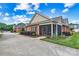 Charming brick home features a screened porch, well-maintained landscaping, and a concrete driveway at 2369 Stardust Ct, Denver, NC 28037