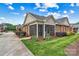 Brick home with a screened-in porch, complemented by green grass and beautiful landscaping at 2369 Stardust Ct, Denver, NC 28037