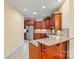 Cherry finished kitchen with granite countertops, stainless steel appliances, and tiled backsplash at 2369 Stardust Ct, Denver, NC 28037