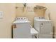Laundry room featuring a white Whirlpool washer and dryer with overhead shelving at 2369 Stardust Ct, Denver, NC 28037