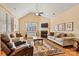 Bright living room features hardwood floors, a fireplace, and vaulted ceilings at 2369 Stardust Ct, Denver, NC 28037
