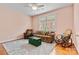 Comfortable living room featuring a ceiling fan, cozy furniture, area rug, and natural light from a window at 2369 Stardust Ct, Denver, NC 28037