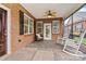 Inviting screened-in porch featuring a ceiling fan, tile flooring, and comfortable seating at 2369 Stardust Ct, Denver, NC 28037