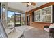 Relaxing screened-in porch with rocking chairs and a ceiling fan with tile flooring at 2369 Stardust Ct, Denver, NC 28037