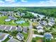 Aerial view of a charming community with a pool, tennis courts and a lake in the distance at 25391 Seagull Dr, Lancaster, SC 29720