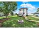 Beautiful backyard with a fire pit, green grass, and a charming two-story home at 25391 Seagull Dr, Lancaster, SC 29720