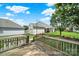 Backyard Deck overlooking a spacious lawn, green trees and a garage in the background at 25391 Seagull Dr, Lancaster, SC 29720
