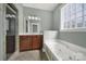 Bathroom with shower, vanity, soaking tub and glass block window for natural light at 25391 Seagull Dr, Lancaster, SC 29720