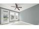 Bedroom with neutral walls, white trim, ceiling fan, and a door leading to the outside at 25391 Seagull Dr, Lancaster, SC 29720