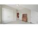 Bedroom featuring neutral colored walls, carpet, and trim plus a built-in hutch and multiple doors at 25391 Seagull Dr, Lancaster, SC 29720