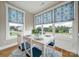 Dining room featuring a white table, blue cushions, and large windows with custom shades at 25391 Seagull Dr, Lancaster, SC 29720
