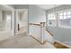 Bright upstairs hallway with carpet, white banister, and natural light streaming through windows at 25391 Seagull Dr, Lancaster, SC 29720