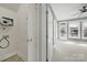 Hallway featuring a laundry area, multiple doors, and a view of a room with an exterior door at 25391 Seagull Dr, Lancaster, SC 29720