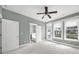 Main bedroom with exterior access, ceiling fan, neutral walls and a glimpse into the en-suite bathroom at 25391 Seagull Dr, Lancaster, SC 29720