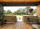 Inviting covered back porch with a view of the fire pit and backyard, perfect for outdoor entertaining at 2553 Elkwood Cir, Charlotte, NC 28205