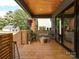 Cozy covered back porch with outdoor seating, overlooking a well-maintained backyard at 2553 Elkwood Cir, Charlotte, NC 28205
