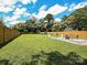 Expansive backyard featuring a fire pit area, a well-manicured lawn, and surrounded by mature trees at 2553 Elkwood Cir, Charlotte, NC 28205