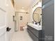Modern bathroom featuring a double sink vanity, hexagon tile floors, and a shower with subway tile surround at 2553 Elkwood Cir, Charlotte, NC 28205