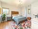 Bright bedroom with a wooden headboard, hardwood floors, and a colorful rug with lots of natural light at 2553 Elkwood Cir, Charlotte, NC 28205
