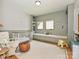 Charming Bedroom featuring built-in shelves, a cozy window seat, and a crib with cheerful decor at 2553 Elkwood Cir, Charlotte, NC 28205