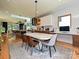 Open-concept dining room featuring a large stone table, modern lighting, and a view of the kitchen at 2553 Elkwood Cir, Charlotte, NC 28205