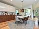 Open-concept dining area with a stone-topped table, hardwood floors, and modern finishes at 2553 Elkwood Cir, Charlotte, NC 28205