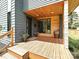 Inviting home entrance featuring a wooden porch, gray siding, and contemporary design elements at 2553 Elkwood Cir, Charlotte, NC 28205