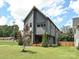 Two-story home showcasing modern architecture, gray siding, well-kept lawn, and landscaped front yard at 2553 Elkwood Cir, Charlotte, NC 28205