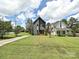 Charming two-story home with modern gray siding, expansive lawn, and neighboring white house at 2553 Elkwood Cir, Charlotte, NC 28205