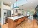 Bright, spacious kitchen with a large island, stainless steel refrigerator, and modern pendant lighting at 2553 Elkwood Cir, Charlotte, NC 28205