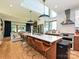 Modern kitchen with an island, hardwood floors, modern lighting, and open layout to living area at 2553 Elkwood Cir, Charlotte, NC 28205