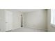 This carpeted bedroom has a window and a white door at 3020 Heathstead Pl # A, Charlotte, NC 28210