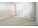 A bright bedroom features neutral carpeting and a large closet at 3020 Heathstead Pl # A, Charlotte, NC 28210
