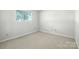 This carpeted bedroom has a view outside at 3020 Heathstead Pl # A, Charlotte, NC 28210
