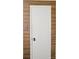 An interior shot of a simple but elegant white door with wood-patterned walls at 3020 Heathstead Pl # A, Charlotte, NC 28210