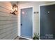 Close-up of a condo unit door with an exterior light fixture and a potted plant at 3020 Heathstead Pl # A, Charlotte, NC 28210