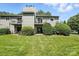 View of the condo featuring a well-maintained lawn and second-story balconies at 3020 Heathstead Pl # A, Charlotte, NC 28210